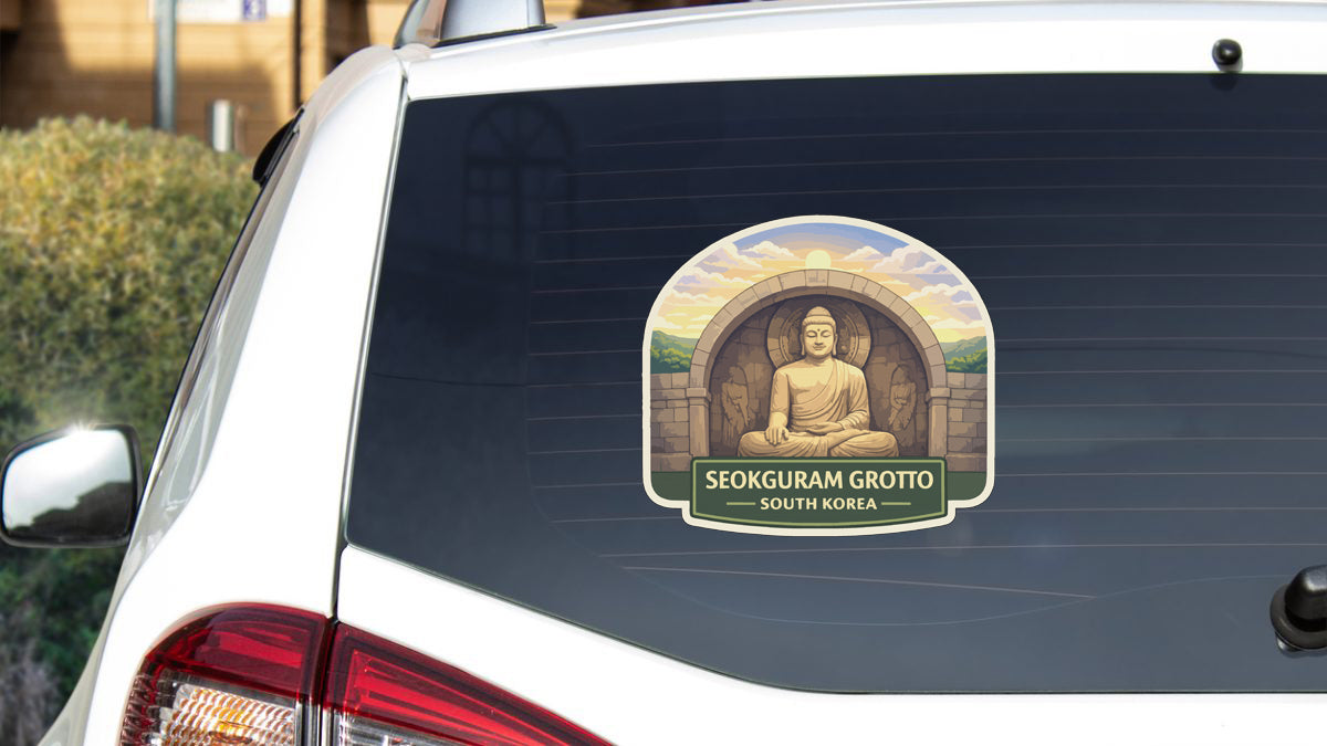 a sticker on the rear window of a car, depicting a Buddha statue and the text "Seokguram Grotto - South Korea".