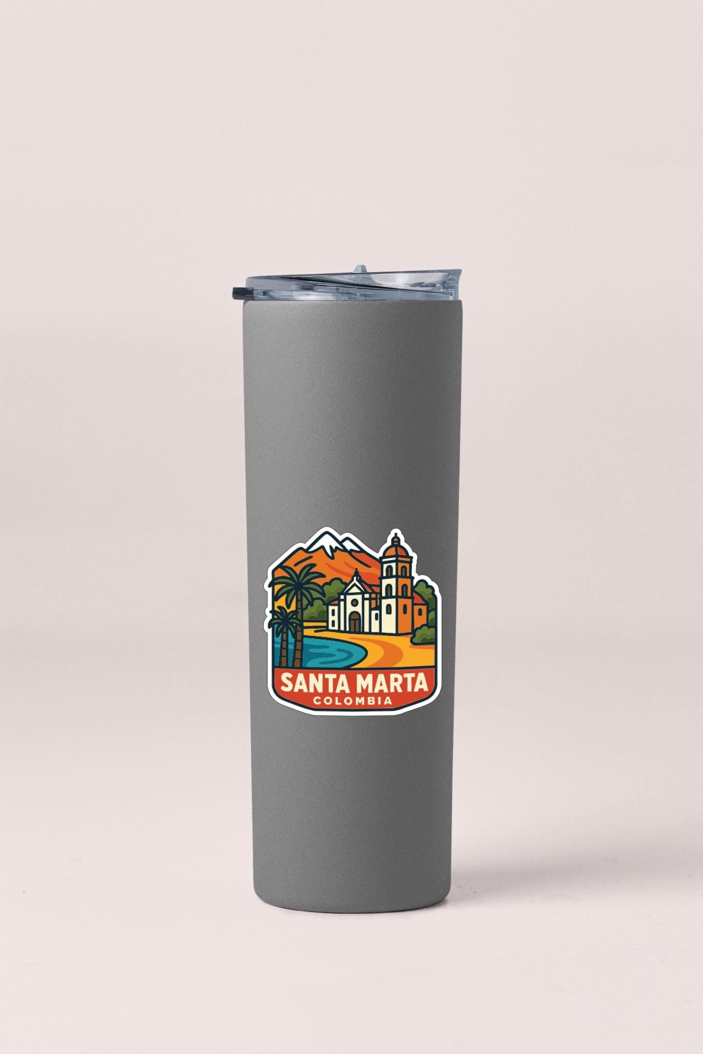 A gray insulated tumbler with a colorful sticker depicting a scenic view of Santa Marta, Colombia.