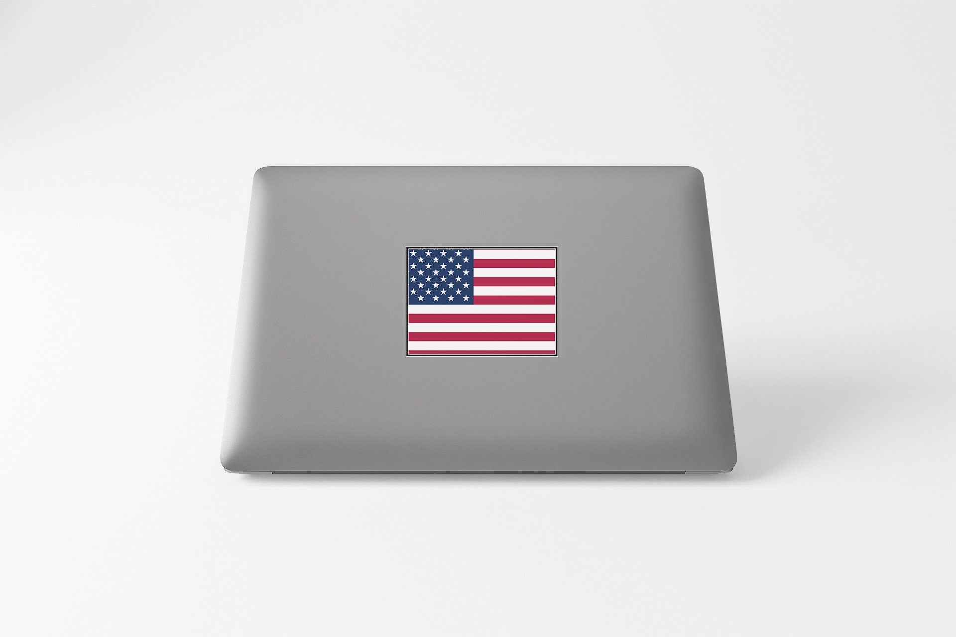 a laptop computer with a flag sticker on it
