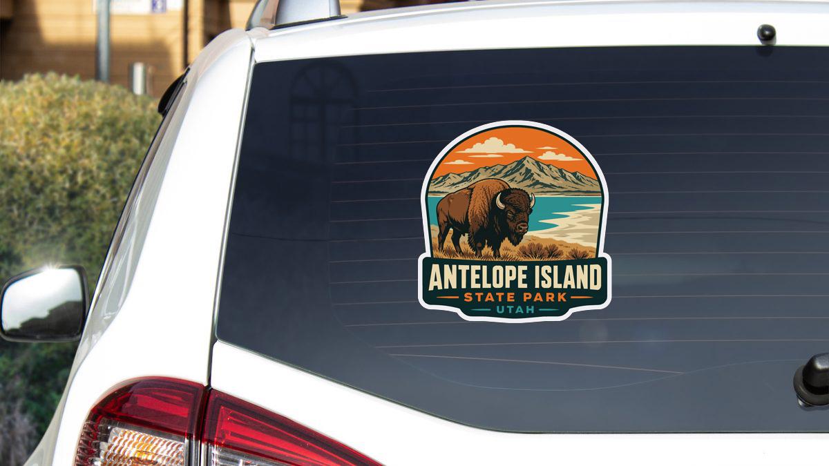 A sticker on the rear window of a car that features an illustration of a bison and the text "ANTELOPE ISLAND STATE PARK UTA".