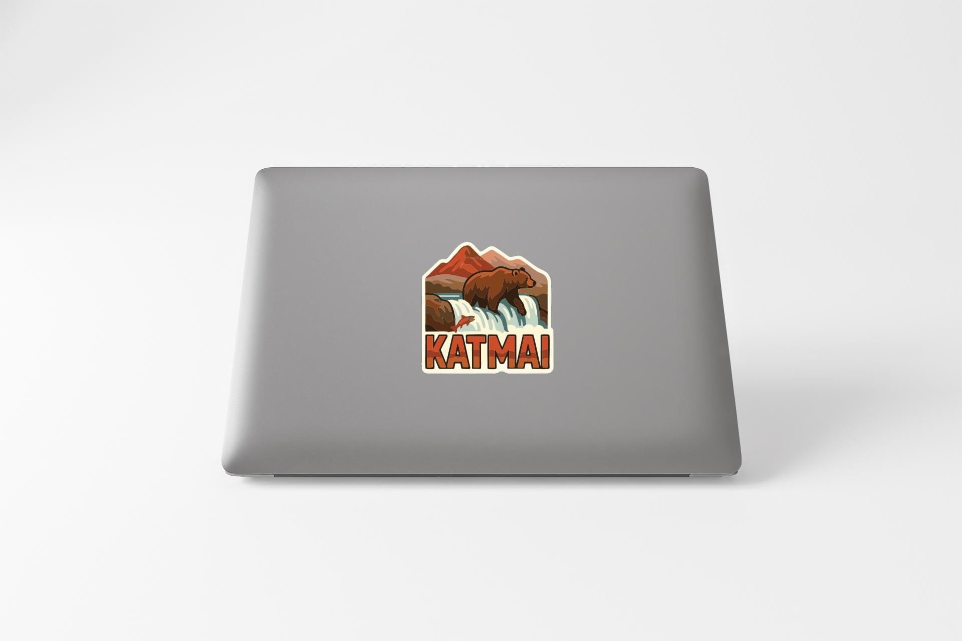 A sticker on the back of a laptop with an illustration of a bear and the word "KATMAI" printed on it.