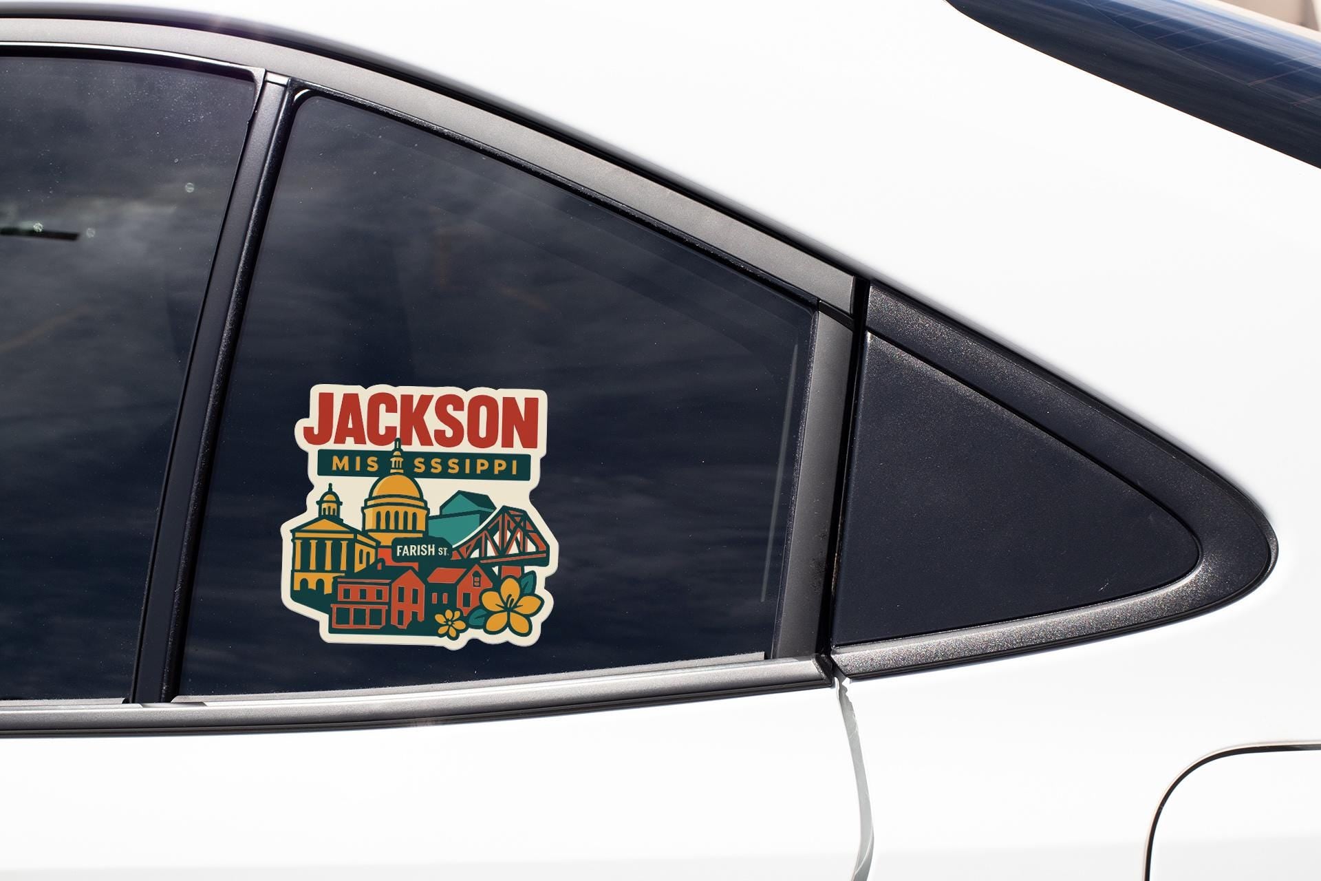 A car window with a sticker on it, featuring a colorful illustration of a cityscape with buildings and landmarks.