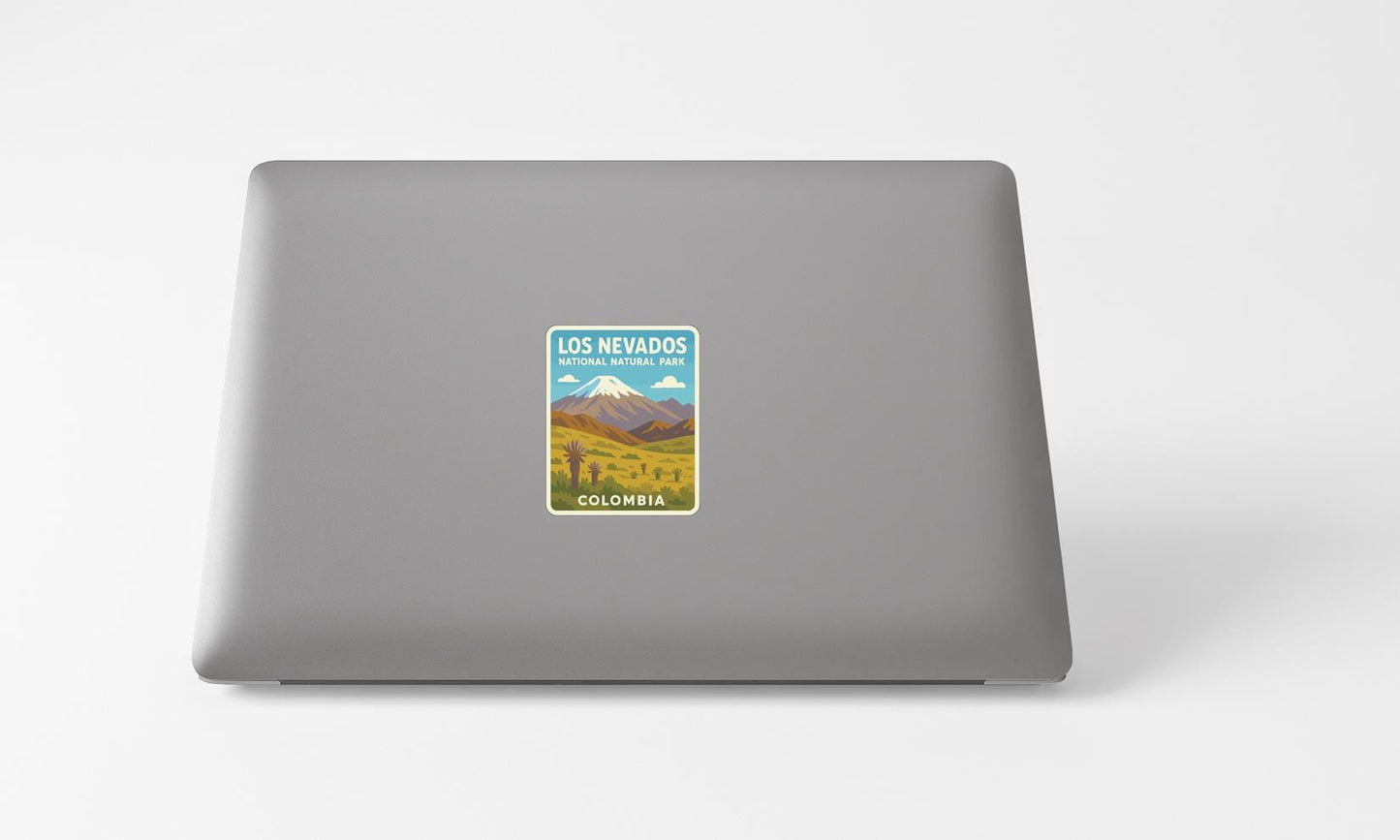 A sticker on the back of a laptop displaying a mountain landscape with text indicating the location as Los Nevados National Park in Colombia.