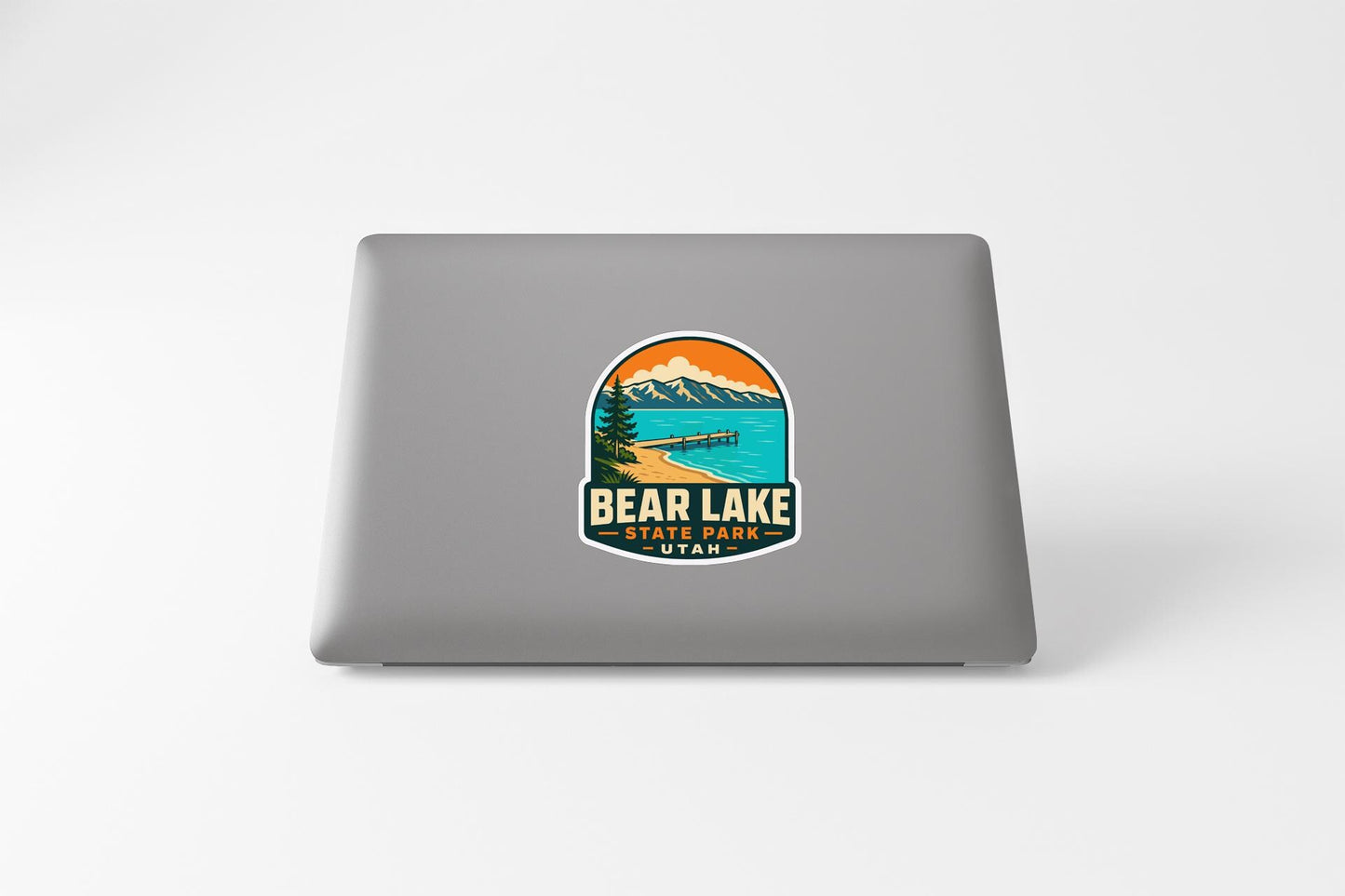a sticker with a mountain landscape and a lake, with the text "BEAR LAKE STEEL PARK UTA" printed on it.