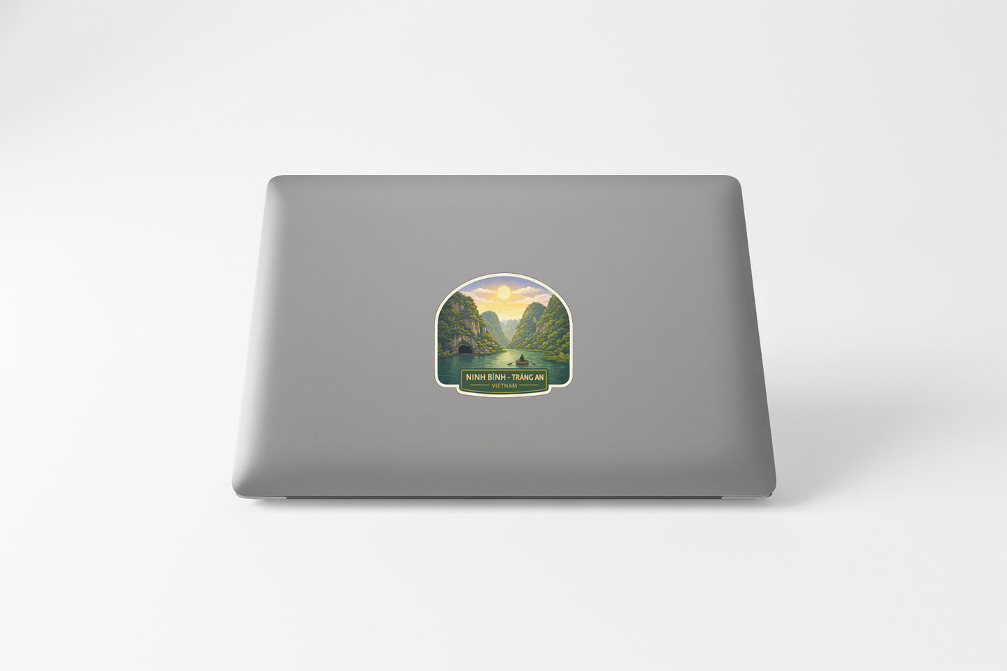 a sticker with a scenic landscape on the back of a laptop.