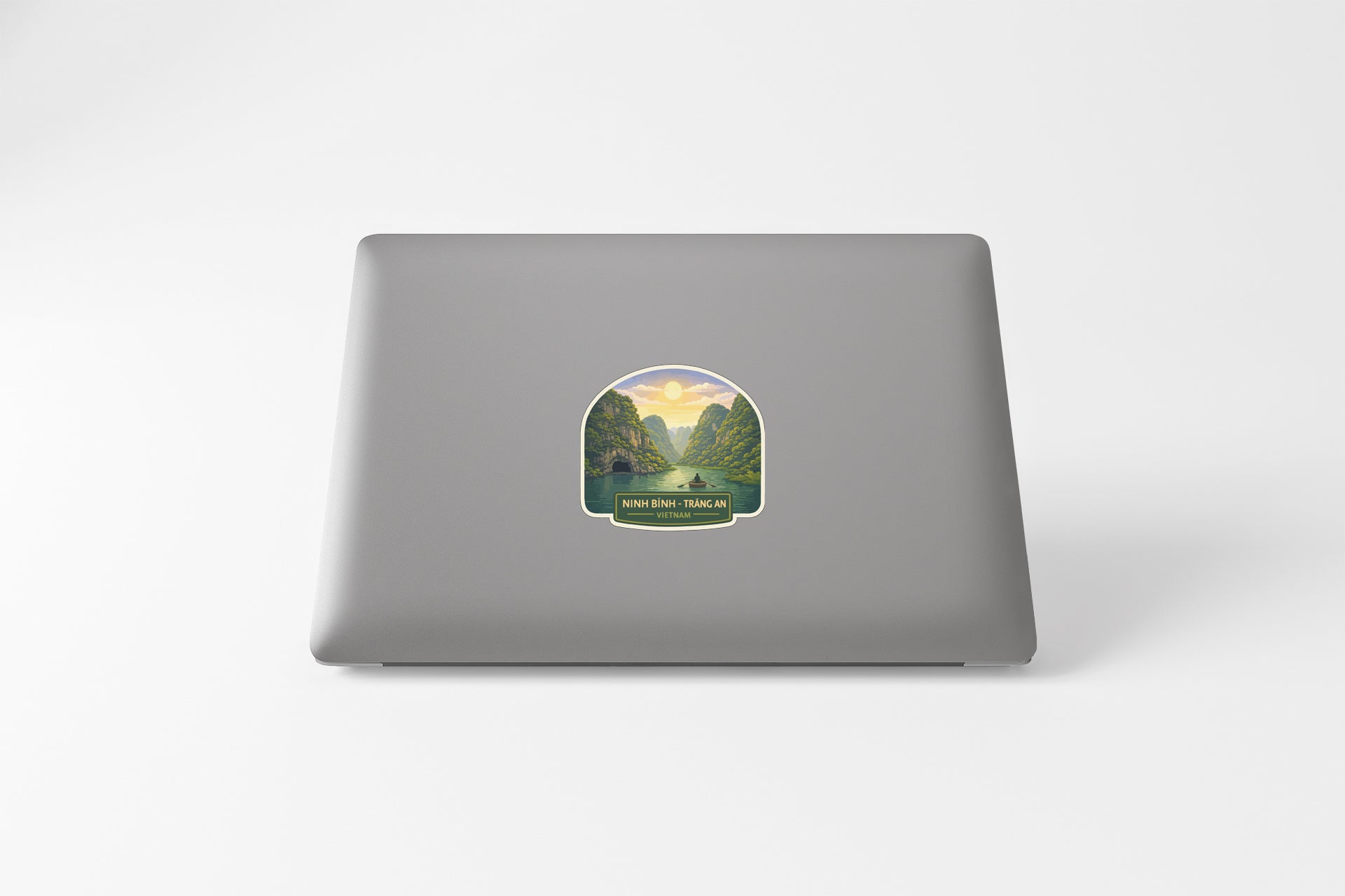 a sticker with a scenic landscape on the back of a laptop.