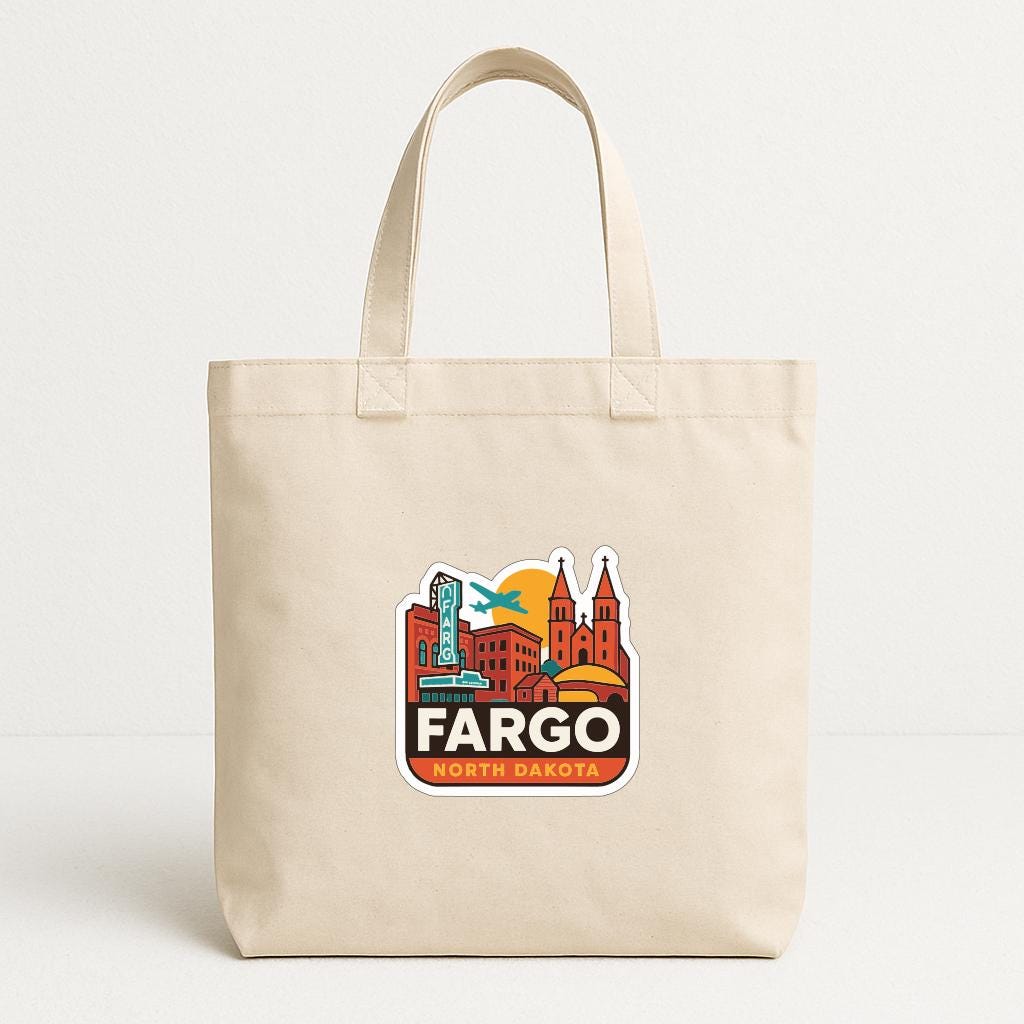 A beige tote bag with a graphic design featuring a city skyline and the text "FARGO NORTH DAKOTA".