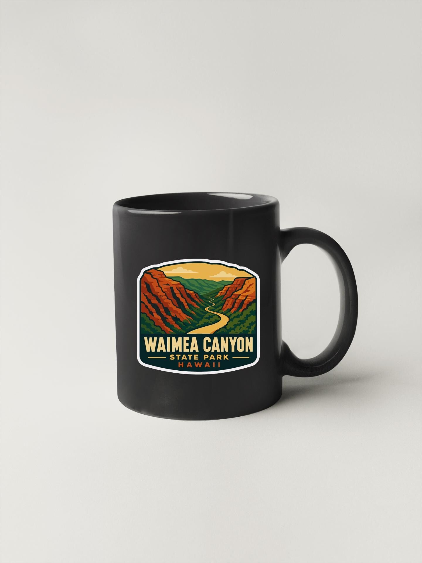A black coffee mug with a graphic design depicting Waimea Canyon State Park in Hawaii.