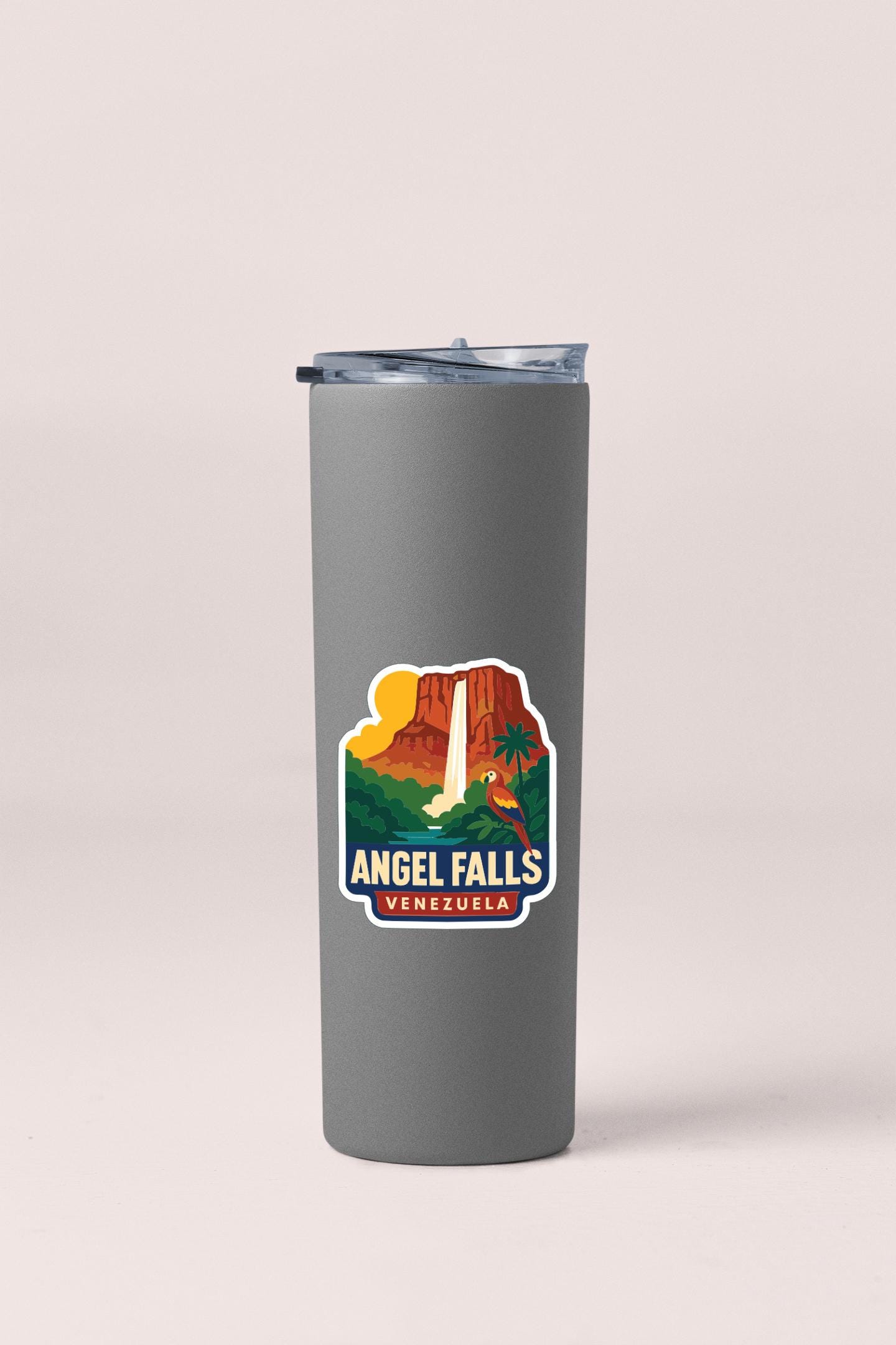 A gray insulated tumbler with a printed sticker depicting the Angel Falls, a famous waterfall located in Venezuela.