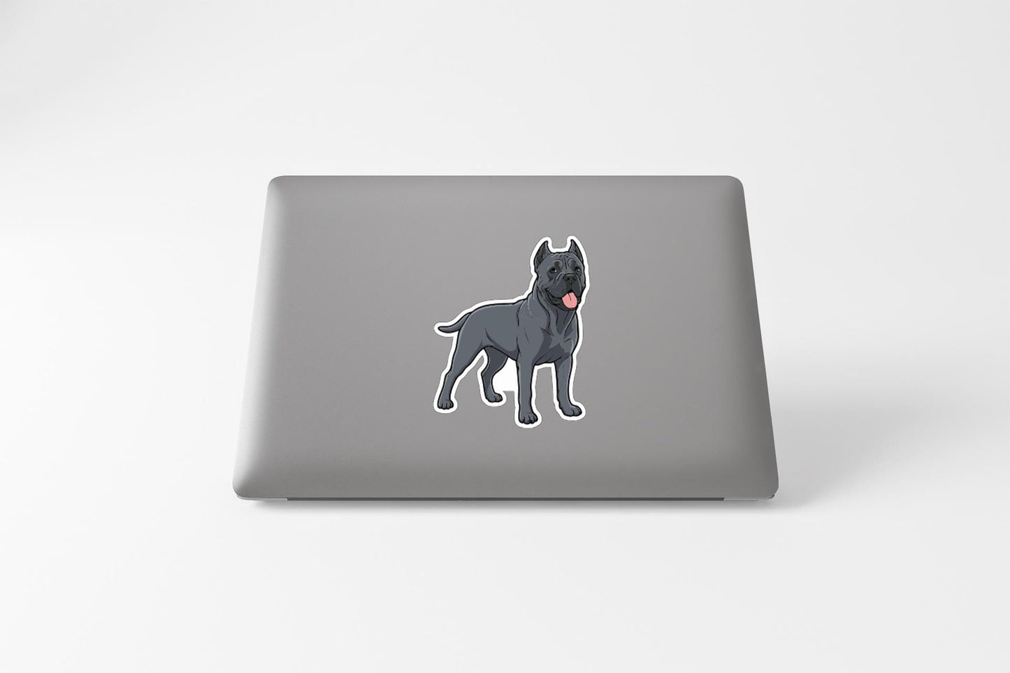 A sticker of a dog on the back of a laptop computer.