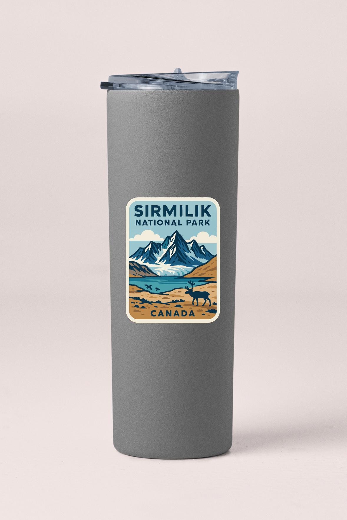 A gray insulated tumbler with a label that says "Sirmilik National Park Canada".