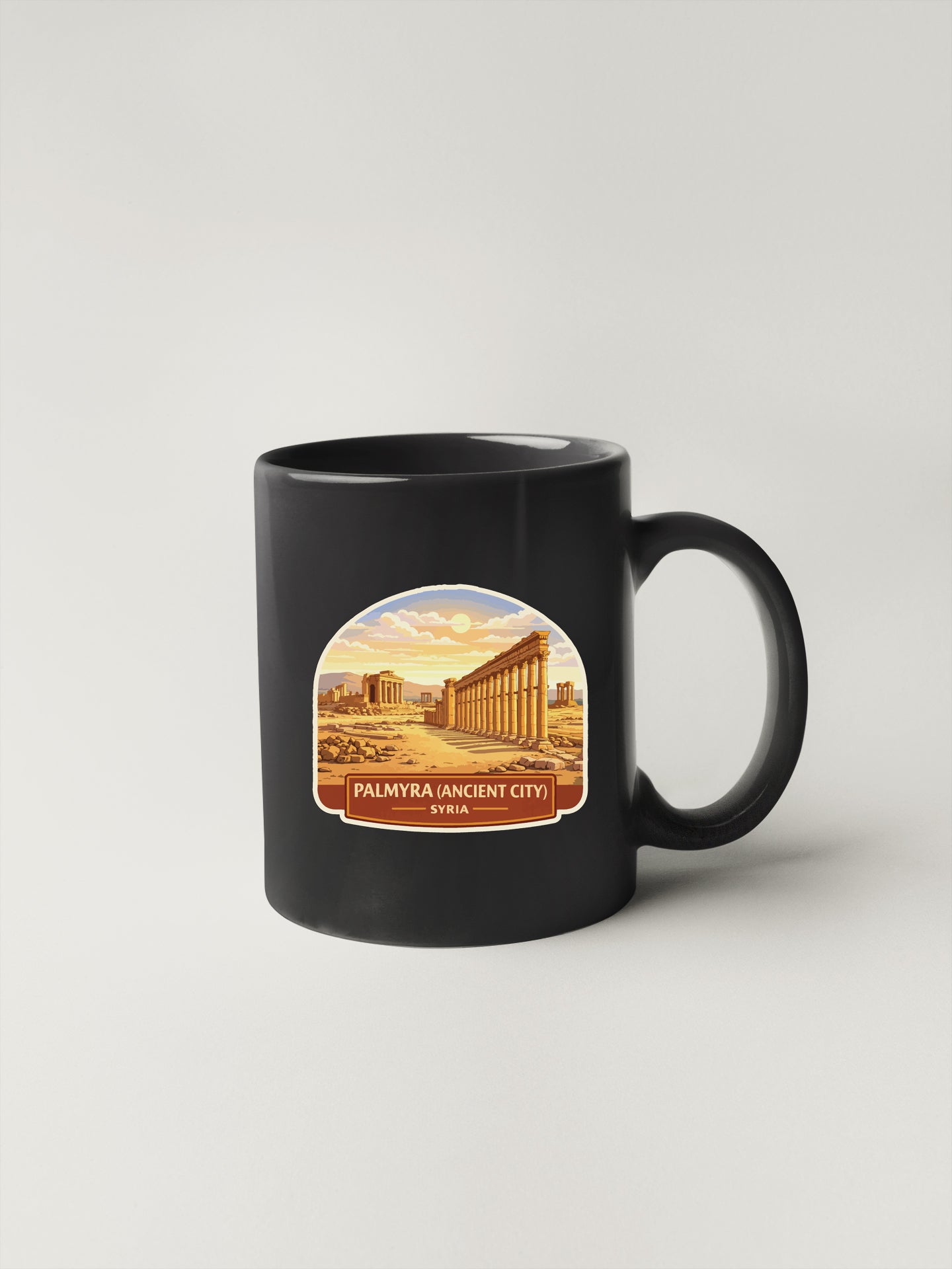 A black coffee mug with a graphic design depicting the ancient city of Palmyra in Syria.