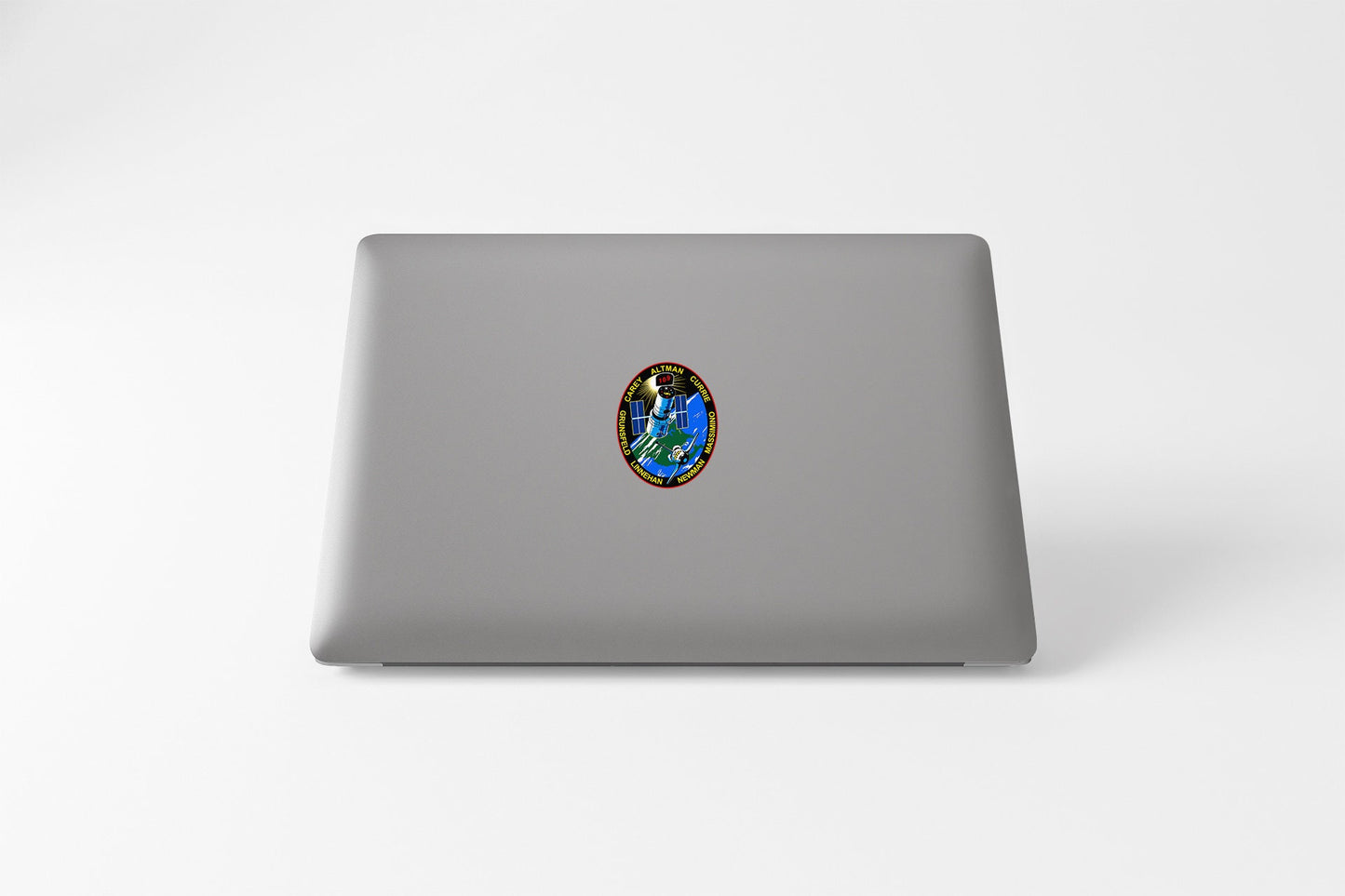 a laptop with a sticker of a picture of a person