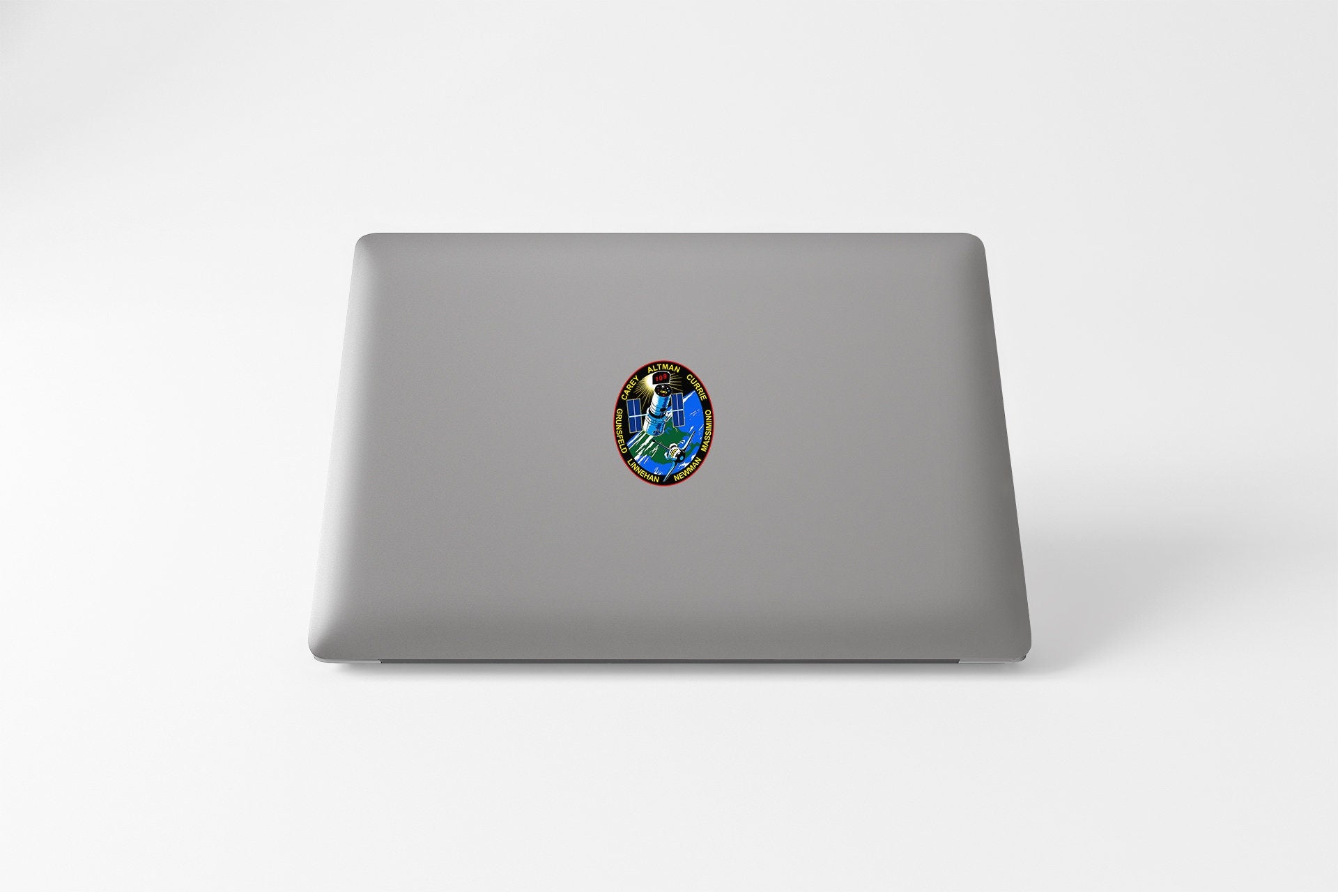 a laptop with a sticker of a picture of a person
