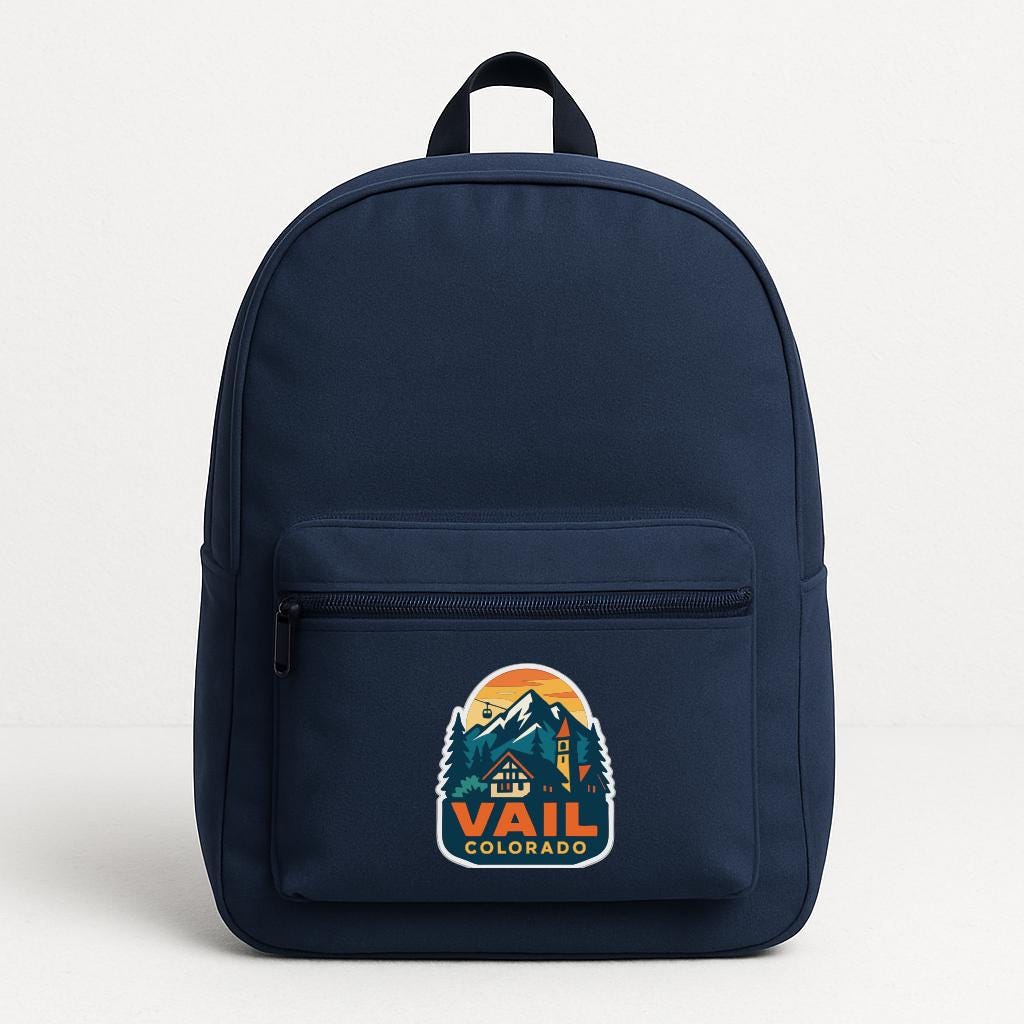 A navy blue backpack with a graphic of a mountain range and the text "Vail, Colorado" printed on it.