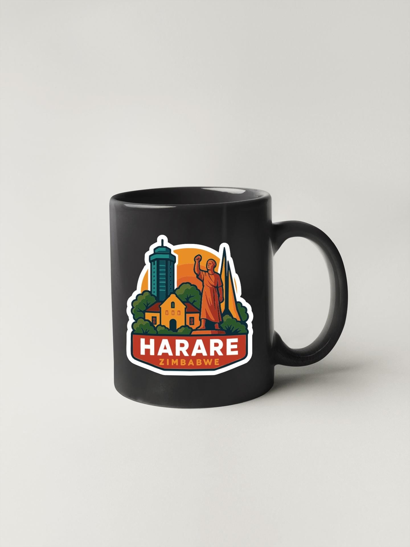 A black coffee mug with a colorful graphic design depicting a city skyline, including a tall building and a statue.