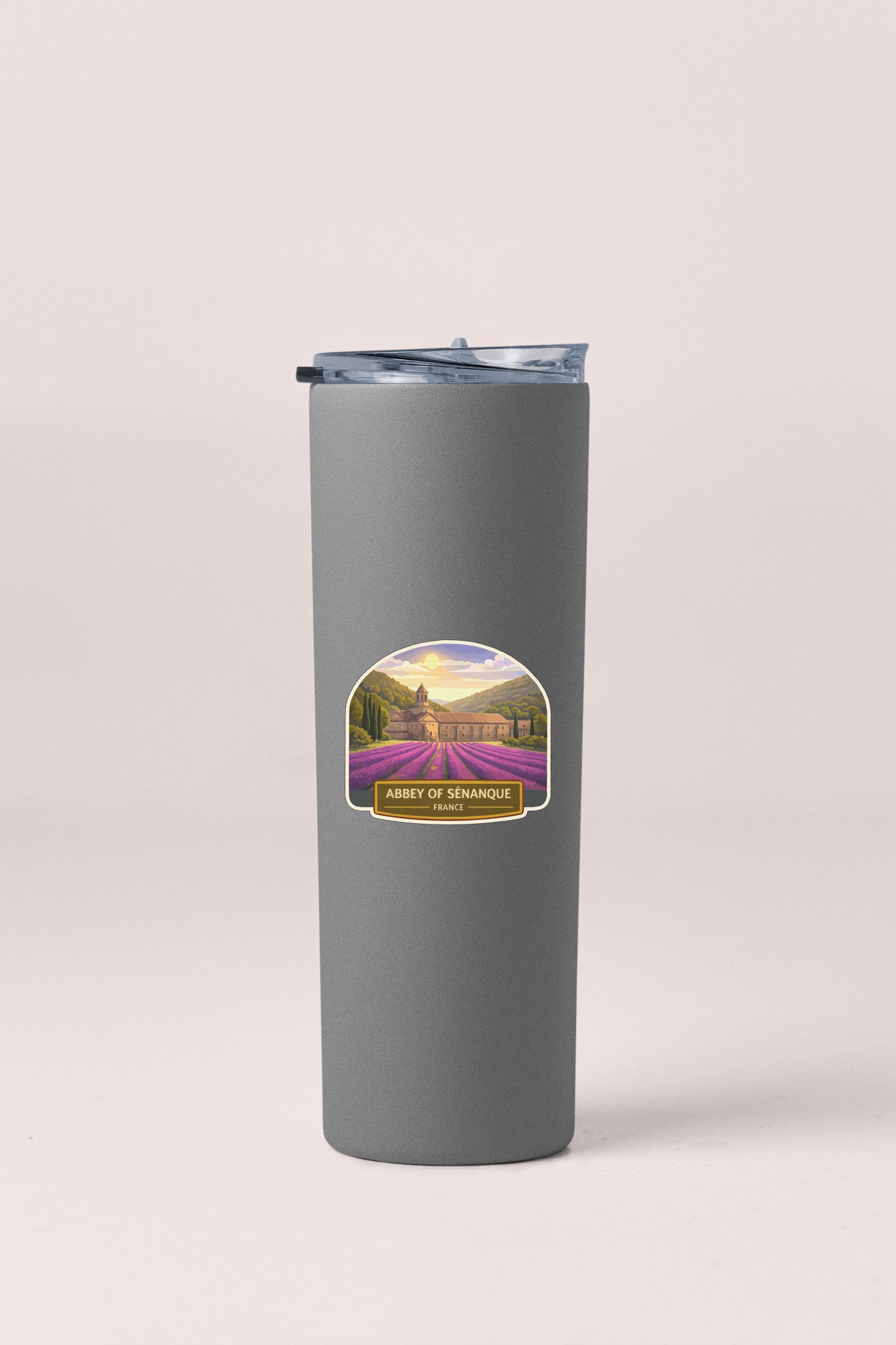 A gray cylindrical container with a lid and a label featuring a scenic landscape.