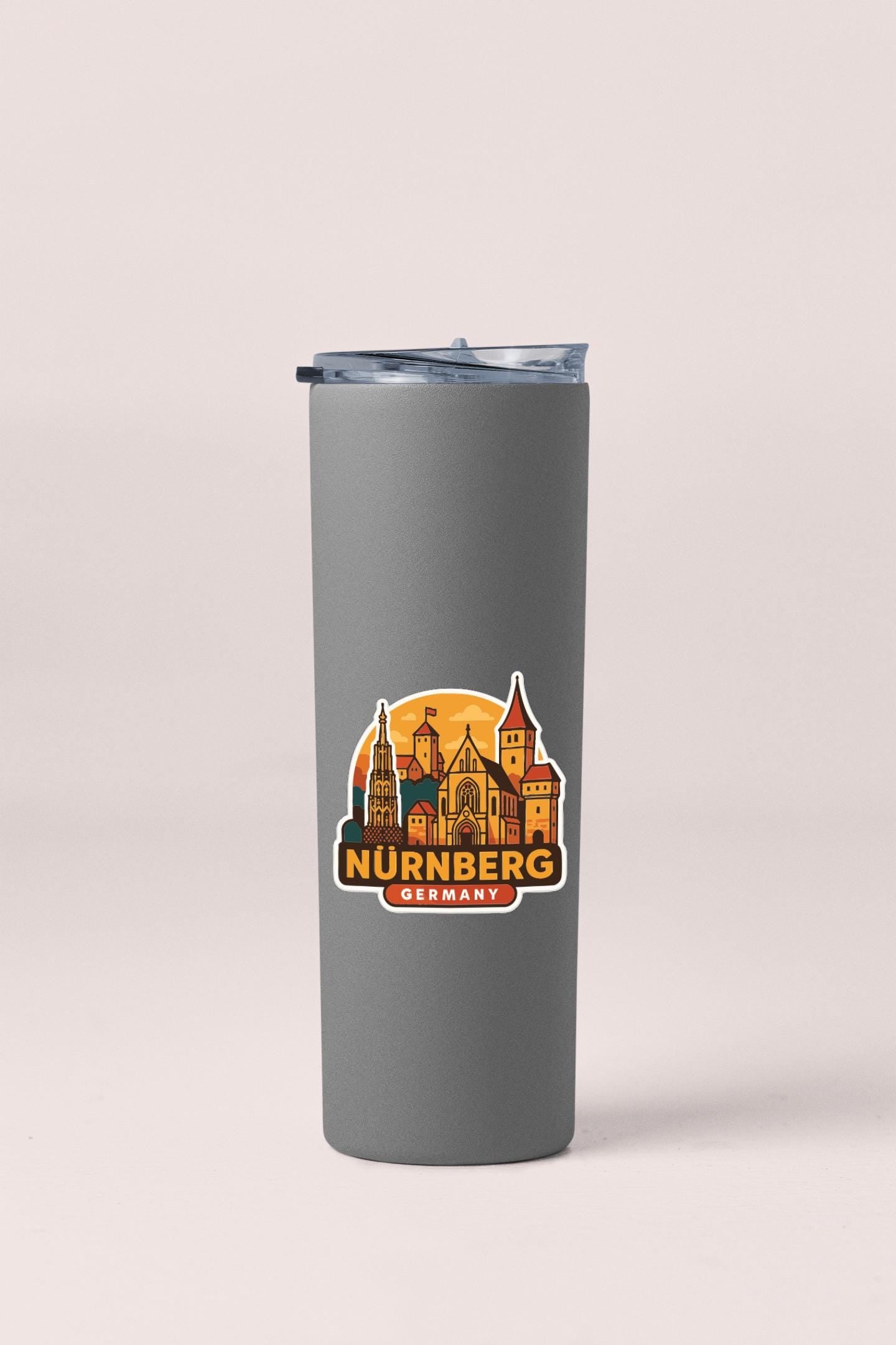 A gray insulated tumbler with a sticker depicting the city of Nurnberg, Germany.