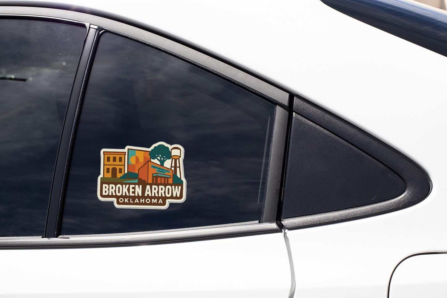A sticker on the side of a car window, featuring an illustration of a building and the text "Broken Arrow, Oklahoma".