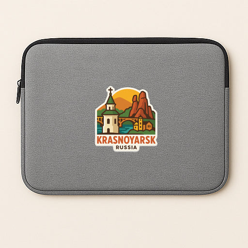 A gray laptop sleeve with a sticker depicting a scenic landscape and the text "Krasnoyarsk Russia".