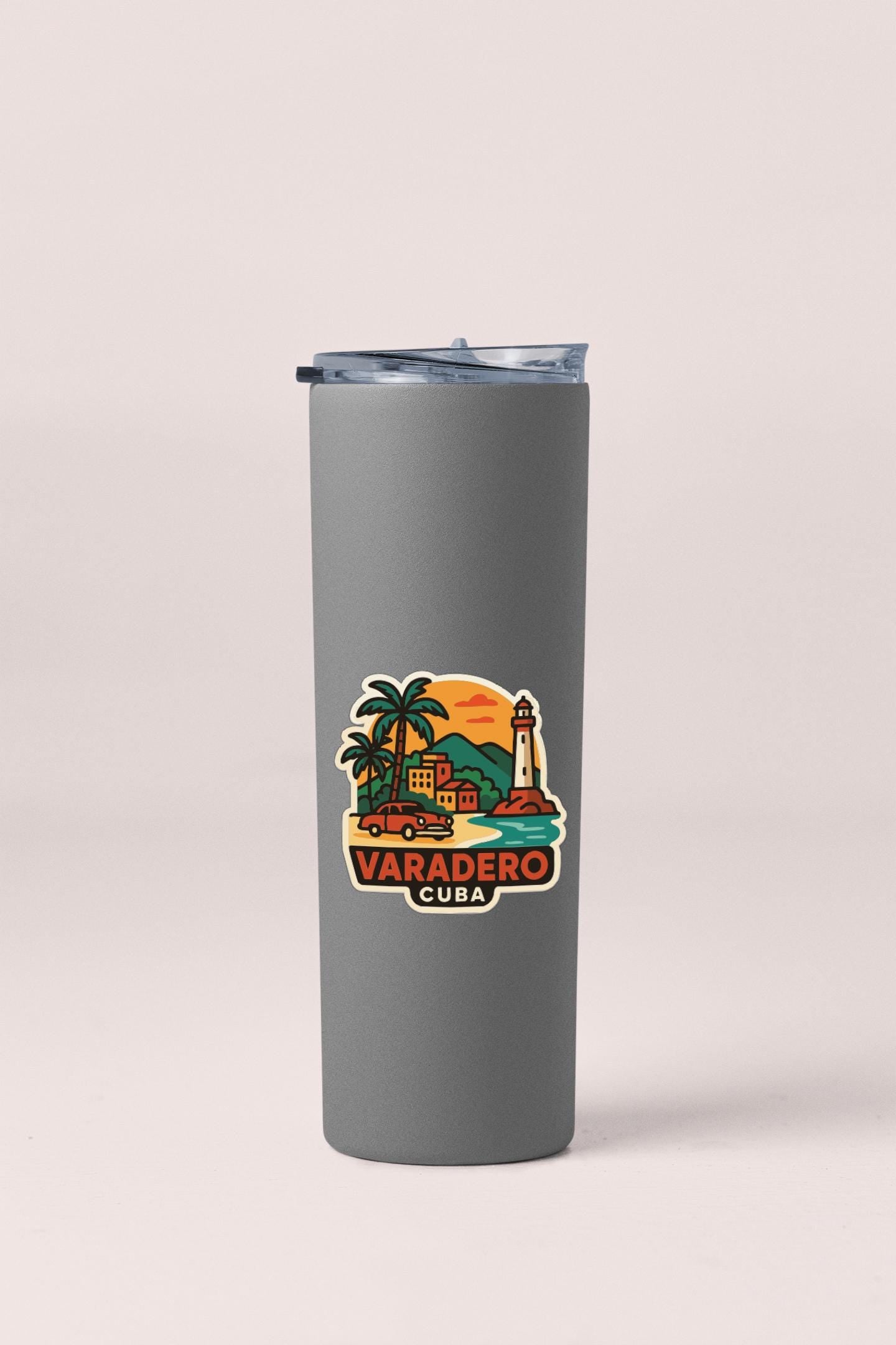 A gray insulated tumbler with a colorful sticker depicting a tropical scene in Varadero, Cuba.