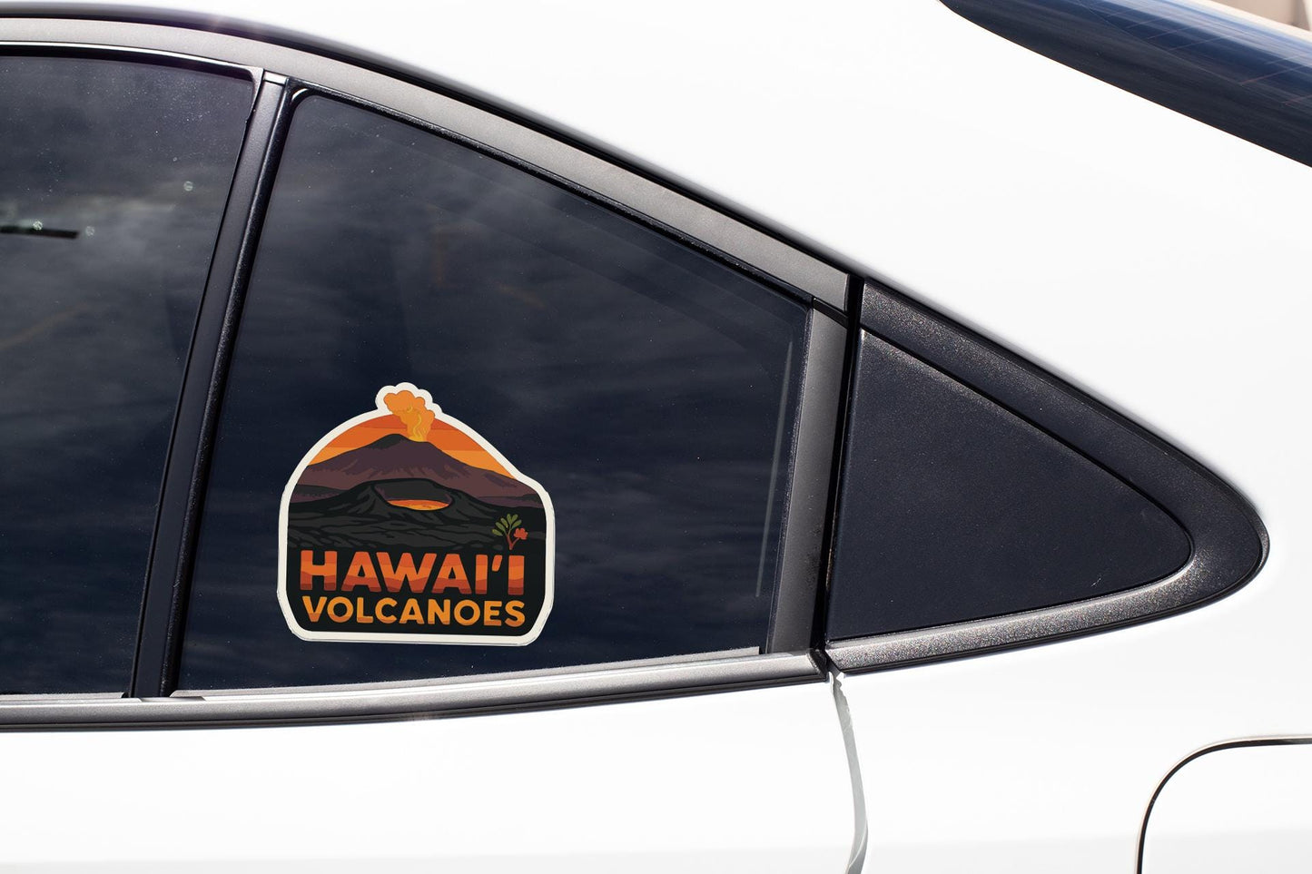 A sticker on the side of a car window that says "Hawaii Volcanoes".
