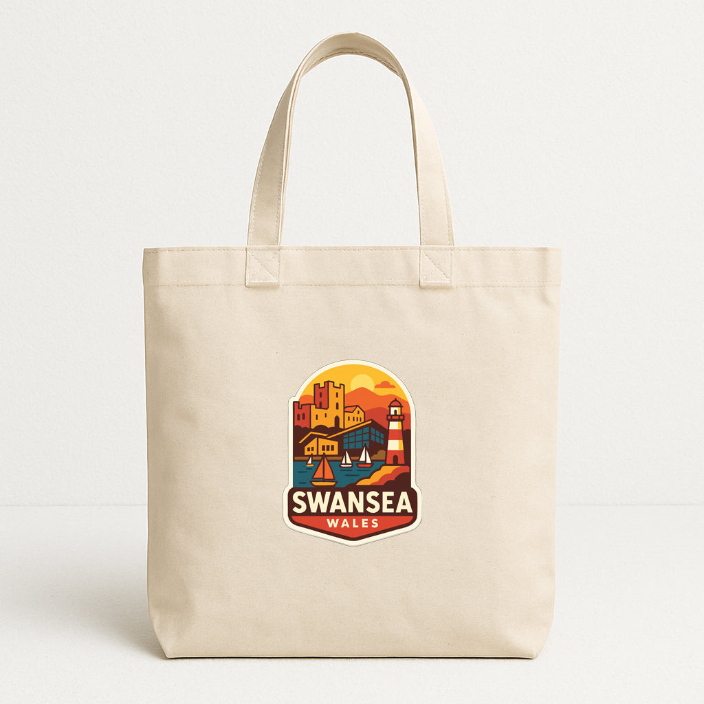 A beige tote bag with a printed design of a cityscape and the text "SWANSEA WALES" on it.