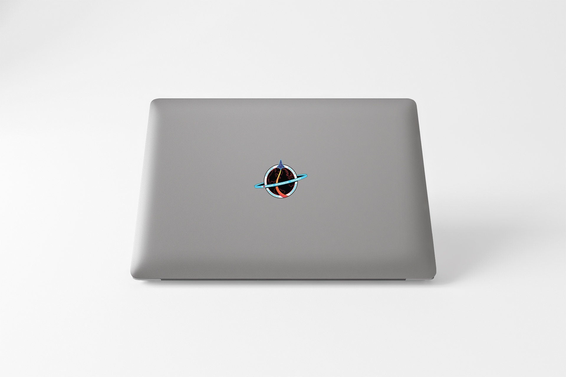 a laptop computer sitting on top of a white table