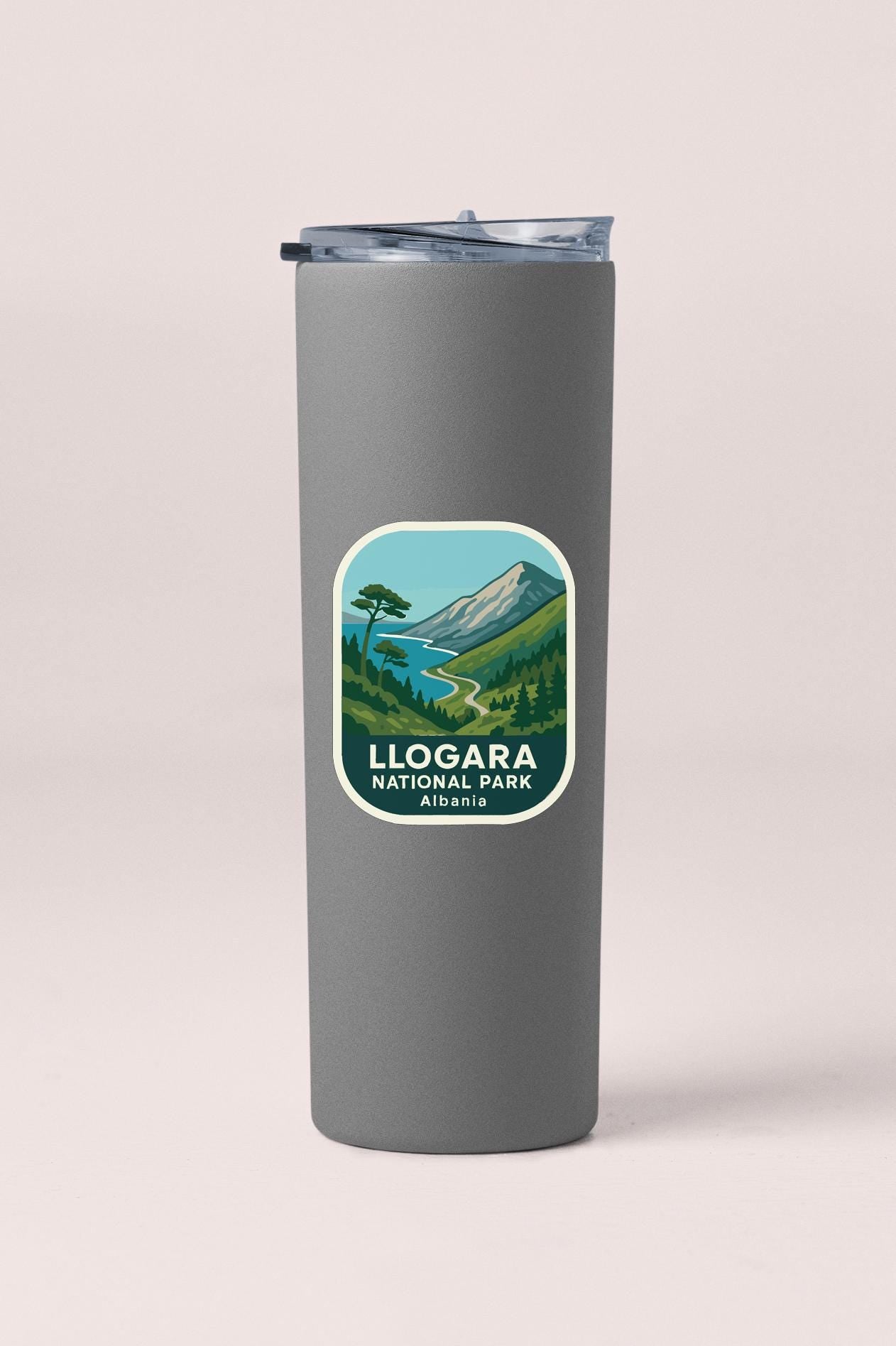 A gray insulated tumbler with a label that says "LLOGARAN NATIONAL PARK AILBANIA".