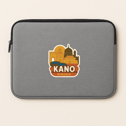 A gray laptop sleeve with a sticker of the city of Kano, Nigeria.