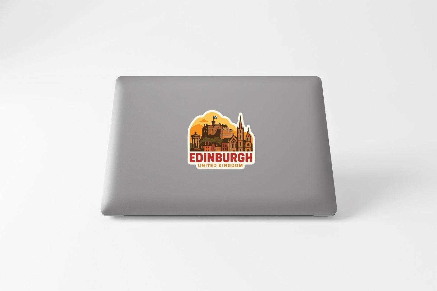 A sticker depicting the cityscape of Edinburgh, United Kingdom, on the back of a laptop computer.