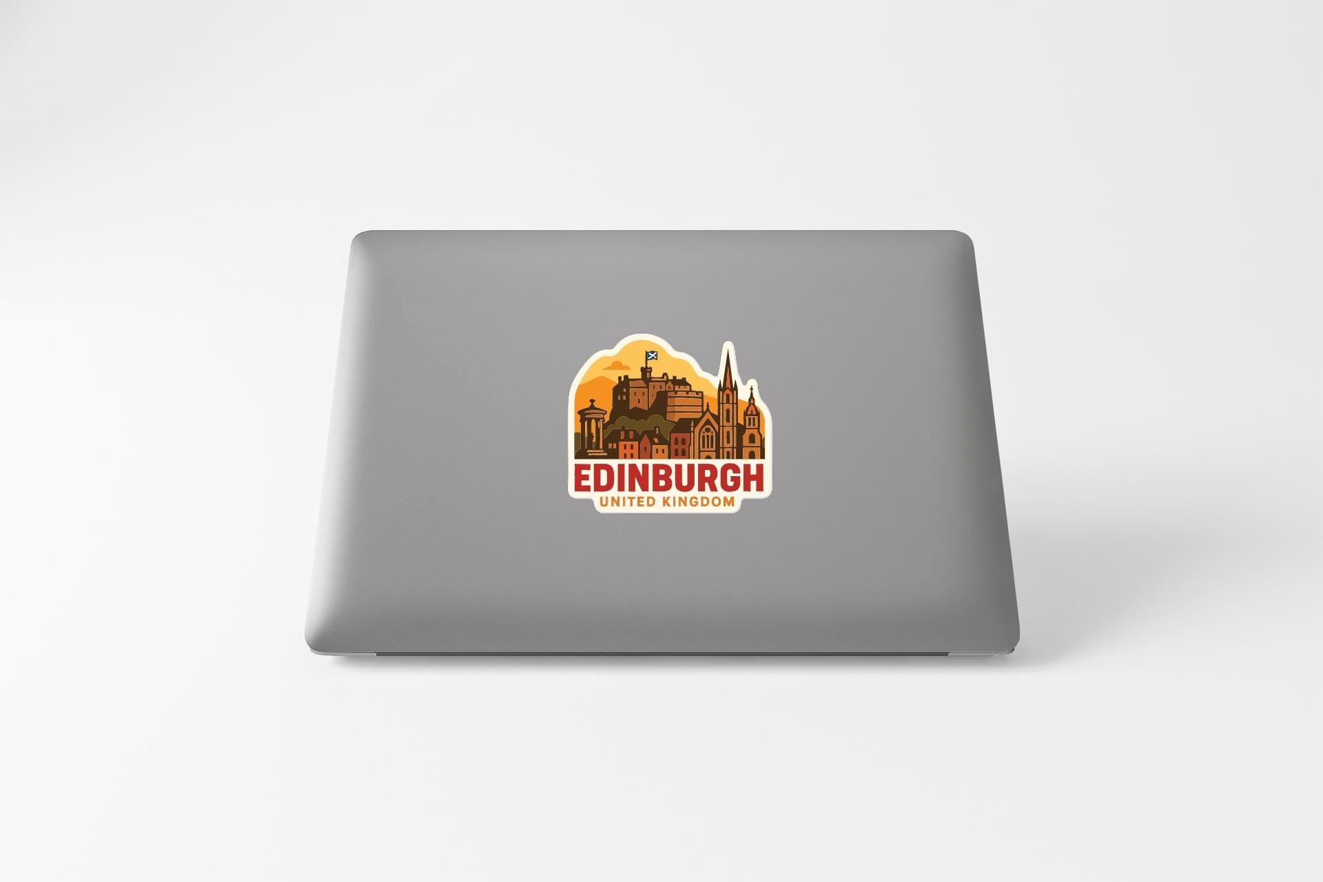 A sticker depicting the cityscape of Edinburgh, United Kingdom, on the back of a laptop computer.