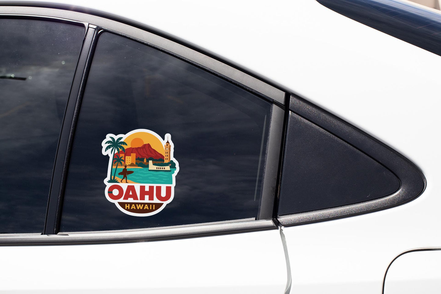 A sticker on the side of a car window depicting a tropical scene with a palm tree, a mountain, and the word "OHAU" in the center.