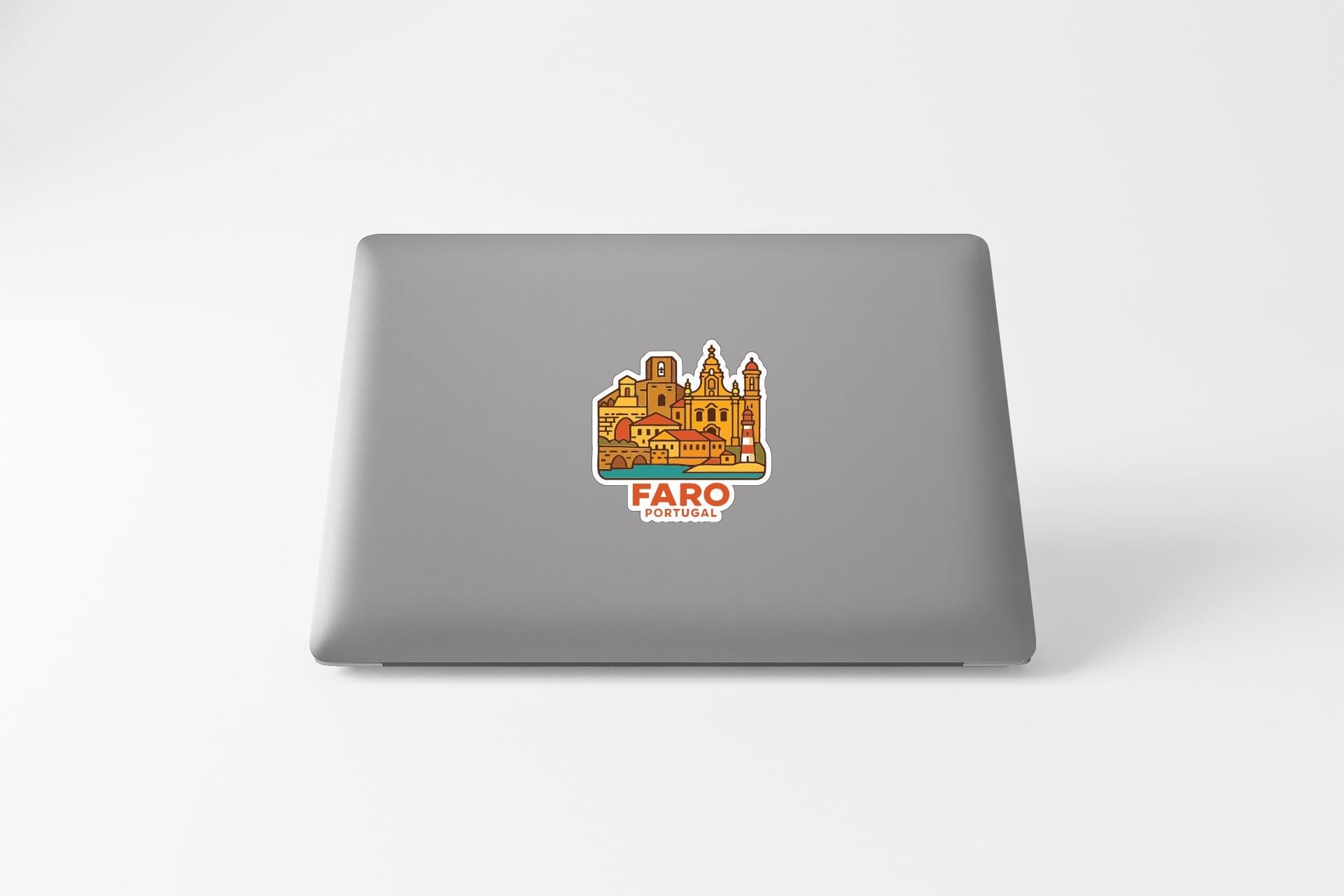 a sticker of a cityscape on the back of a laptop.