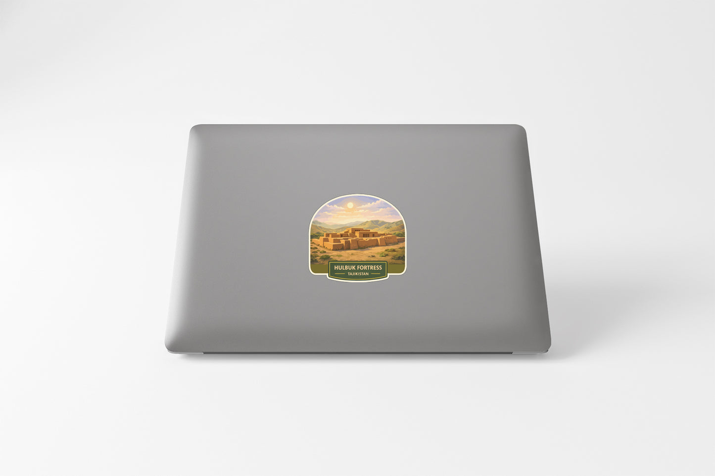 a sticker with a desert landscape on a laptop.