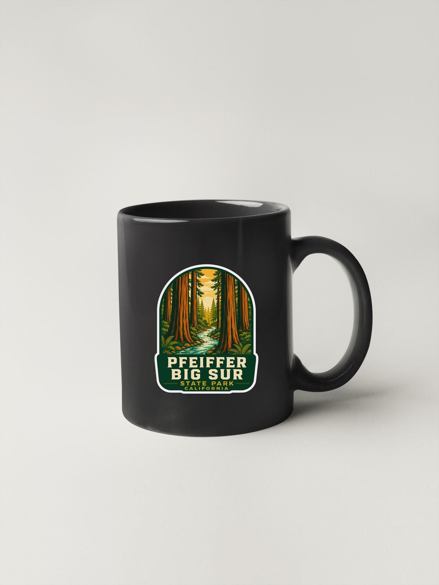A black coffee mug with a label that says "PEIFFER BIG SUR CALIFORNIA".