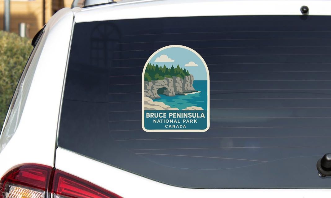 A sticker on the rear window of a vehicle that says "Bruce Peninsula National Park Canada".