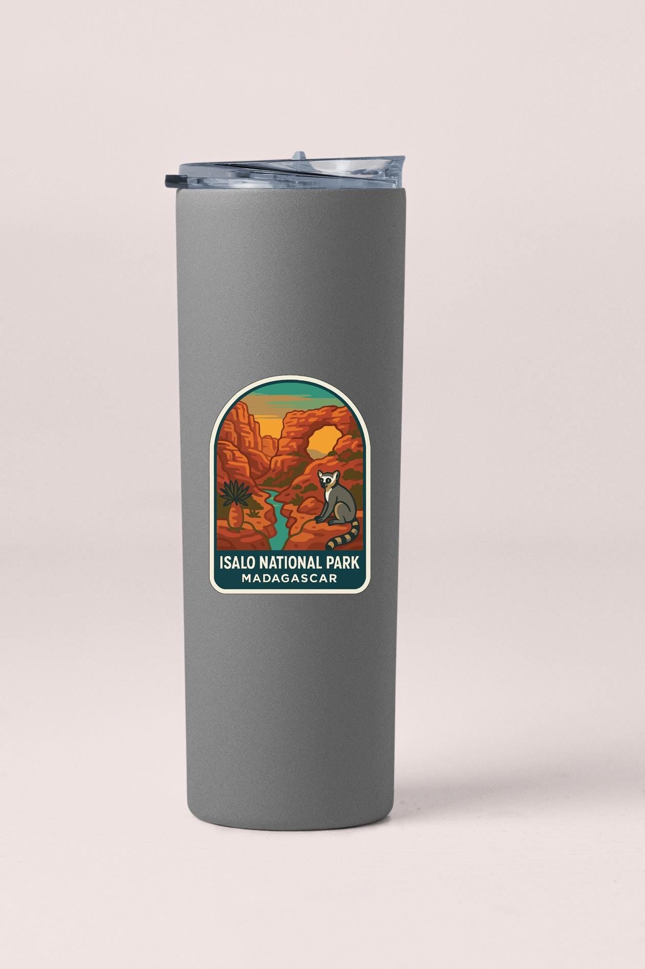 A gray insulated tumbler with a label that features an illustration of a desert landscape and a kangaroo.