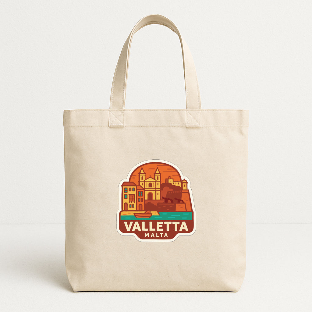 A beige tote bag with a graphic design depicting a cityscape and the text "VALLETA MALTA" printed on it.