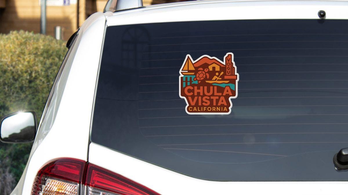 A sticker on the rear window of a white car, displaying the text "CHULA VISTA CALIFORNIA".