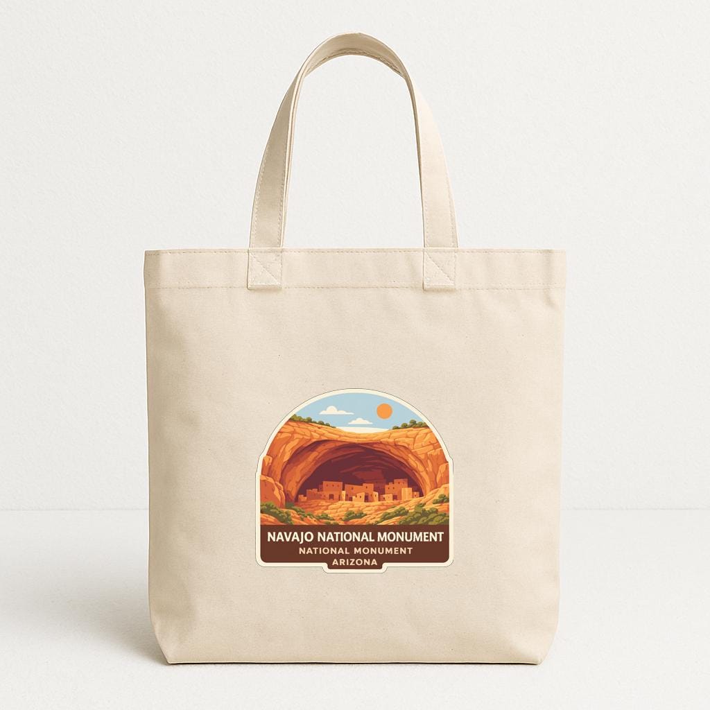 A beige tote bag with a graphic design featuring the Navajo National Monument in Arizona.