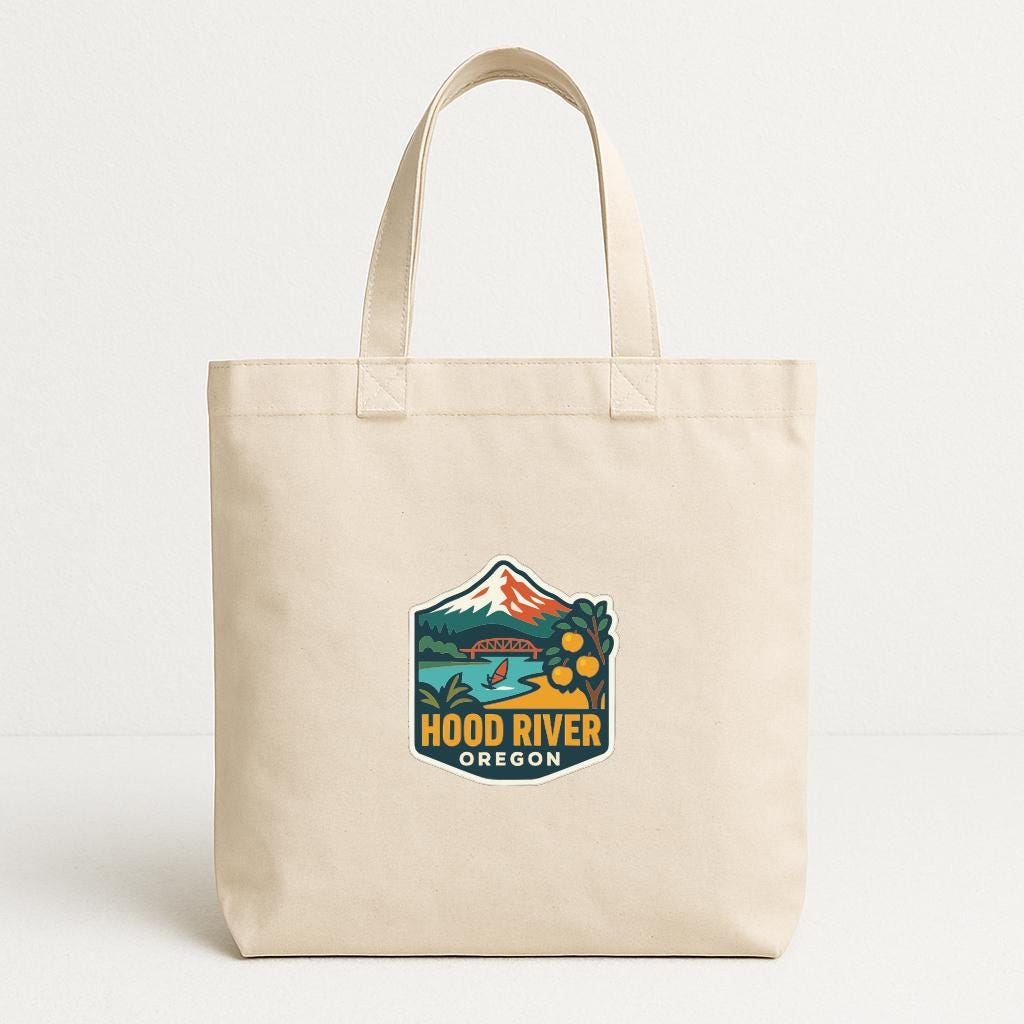 A beige tote bag with a printed logo that says "HOOD RIVER OREGON".