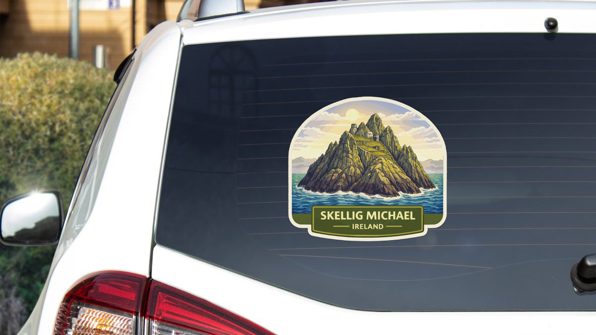 a sticker on the rear window of a car that depicts a mountain landscape with the name 'Skellig Michael Ireland' written below it.