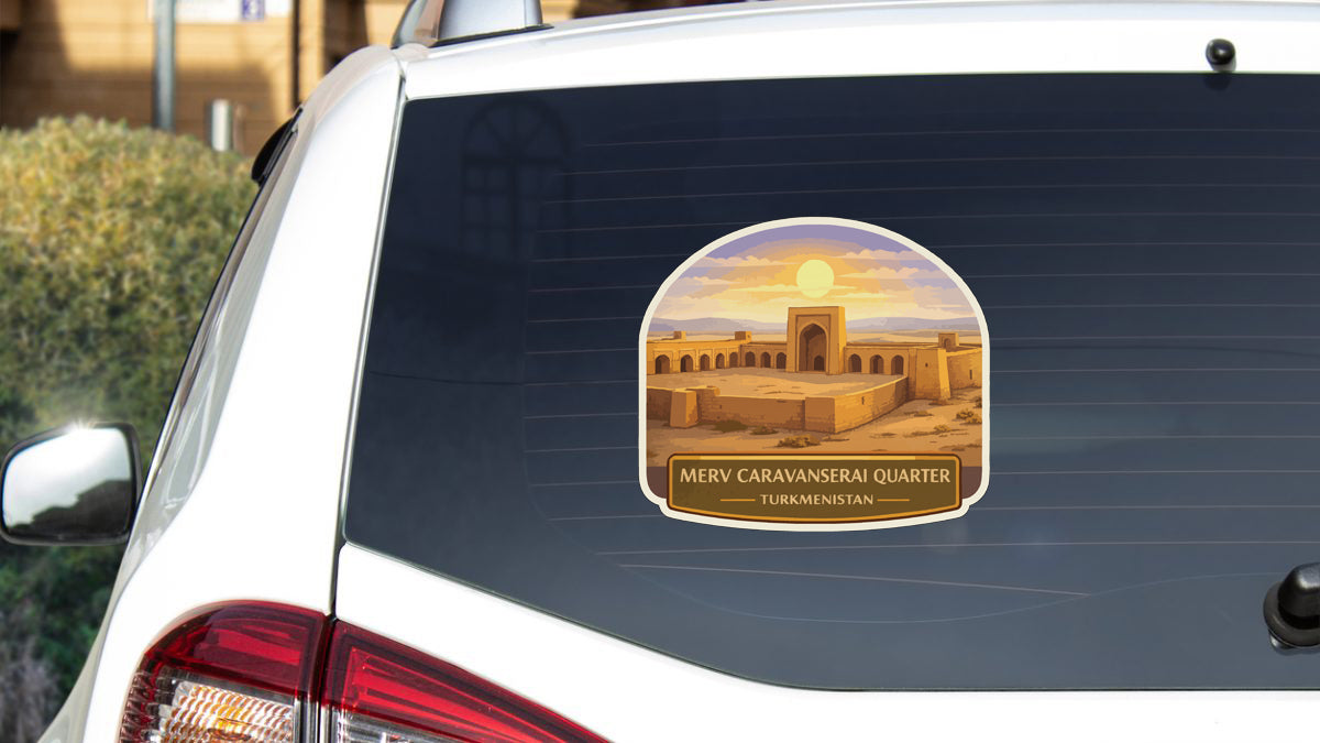 a sticker on the rear window of a car that depicts a desert-like landscape with a building in the background.
