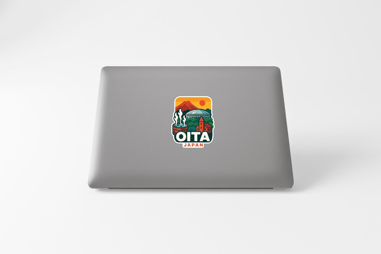 a sticker on the back of a laptop that says "OITA JAPAN".