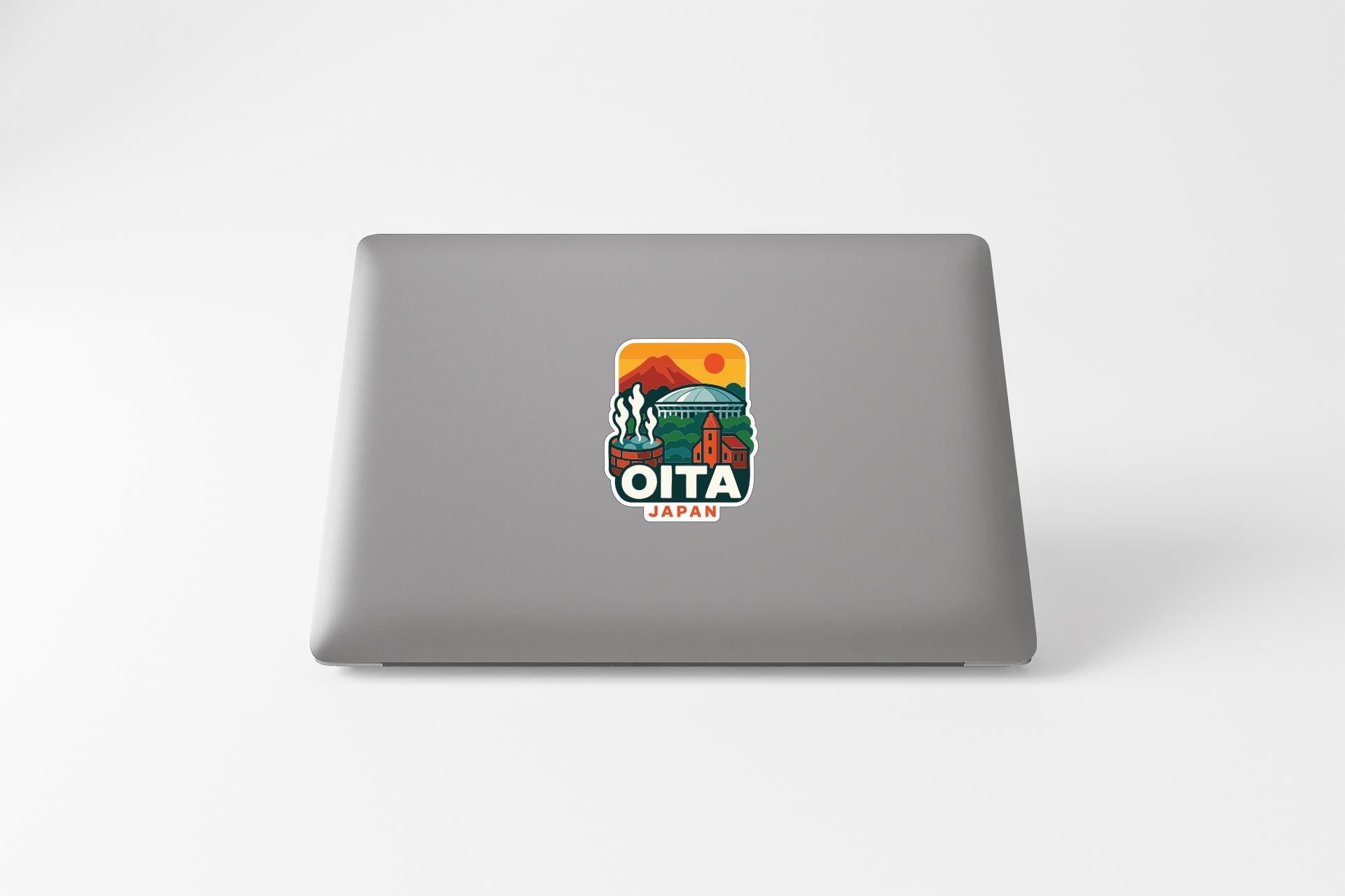 a sticker on the back of a laptop that says "OITA JAPAN".