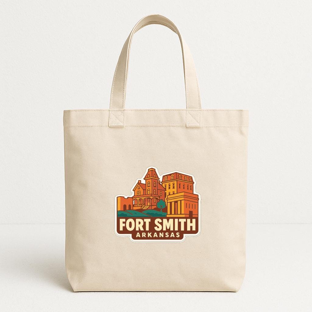 A beige tote bag with a printed design of a building and text that says "Fort Smith Arkansas".