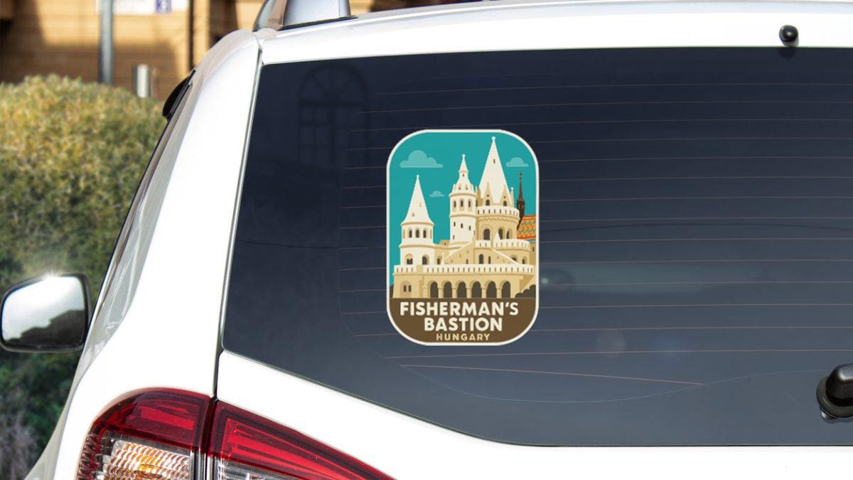 A sticker on the rear window of a white car, depicting a castle or palace-like structure.