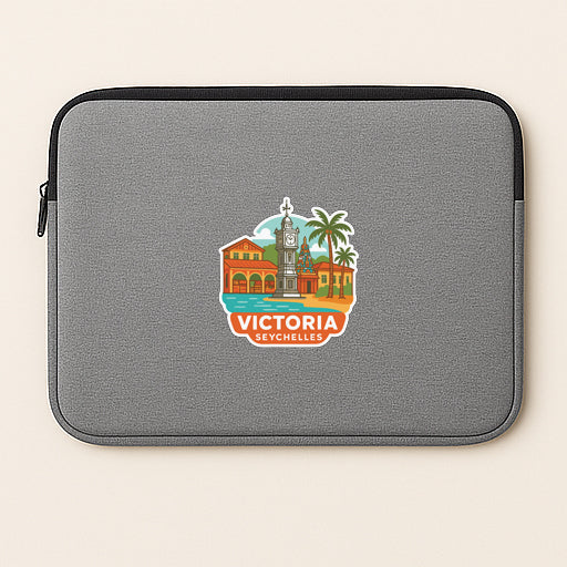 A gray laptop sleeve with a colorful sticker depicting a cityscape and the text "VICTORIA SETCHELLES".