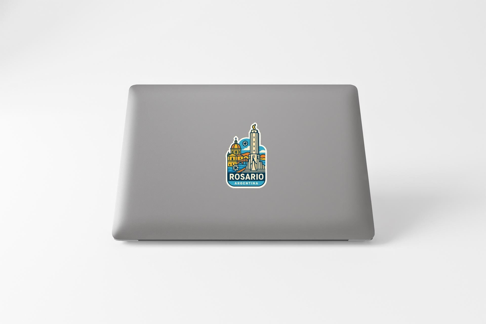 a sticker of Rosario, a city in Argentina, on the back of a laptop.